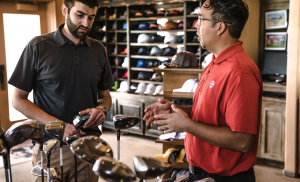 men talking near golf clubs